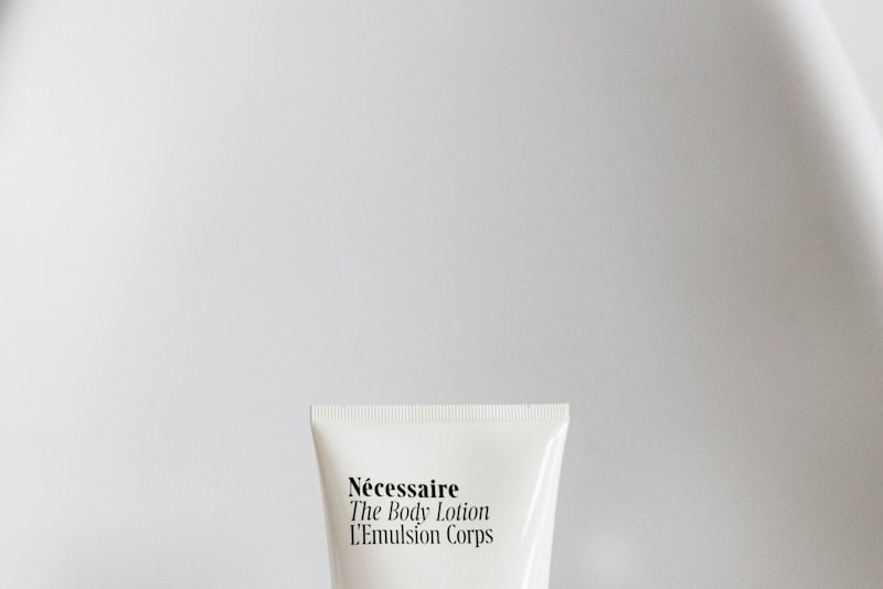 A small dropper bottle of clear serum resting on a soft neutral background